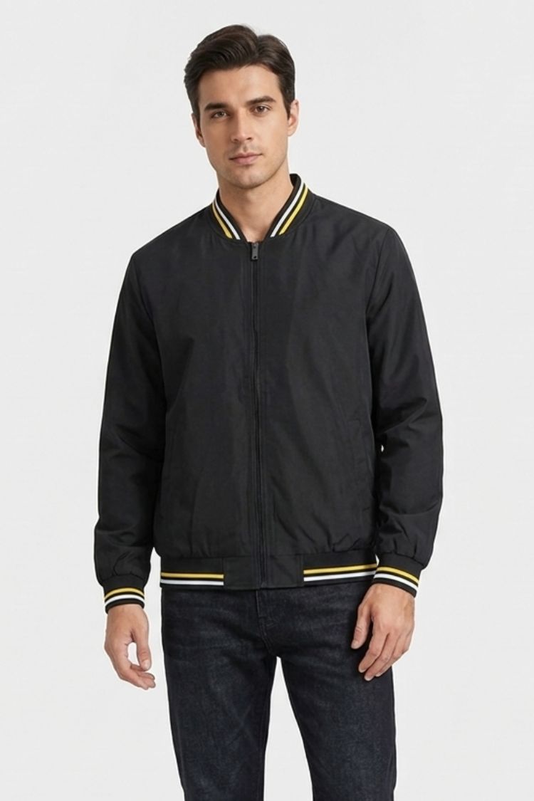Man wearing the black bomber with yellow tipping over a white tee