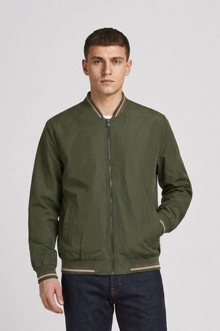Man in the olive green bomber with one hand in the side pocket