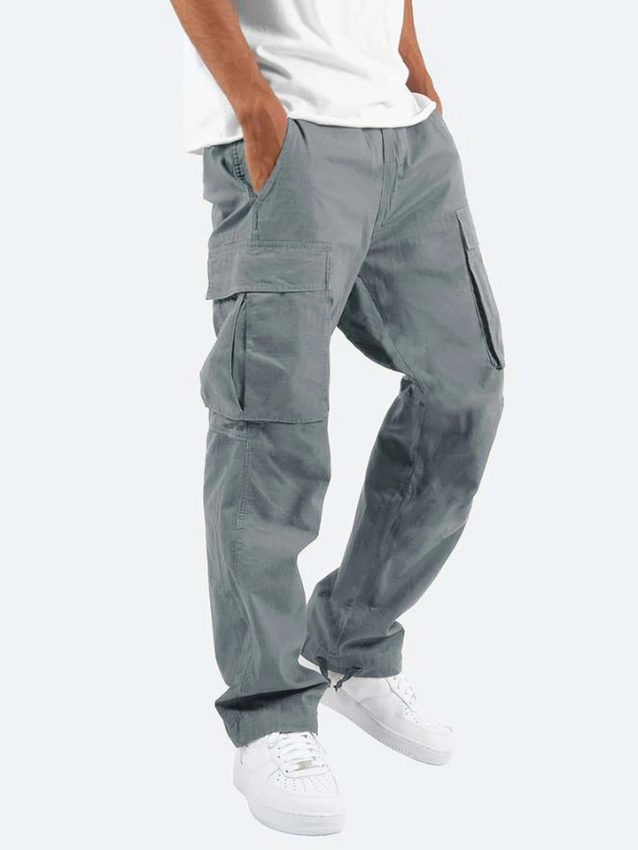 Grey cargo trousers worn with a white tee and trainers