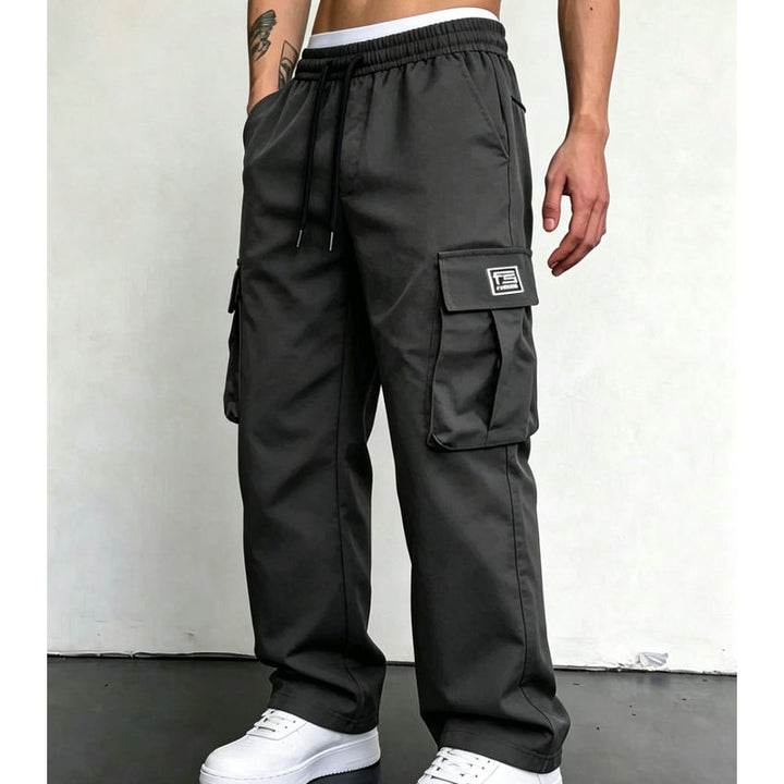Charcoal wide leg cargo trousers worn with white trainers