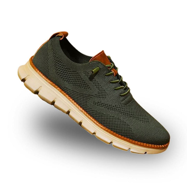Olive green knit wingtip trainer with tan heel tab and cream sole, three-quarter view