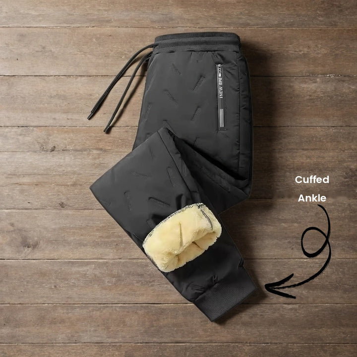 Black joggers with cuffed ankle folded to show the plush lining