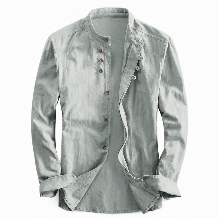 Sage green long sleeve shirt with a stand-up neckline and brown buttons laid flat