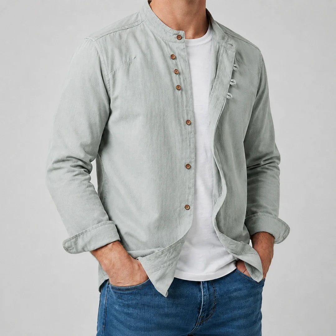 Men's grandad collar shirt in sage green worn open over a white tee with denim