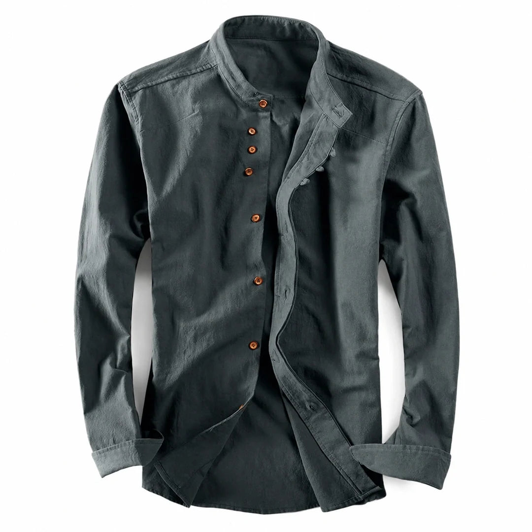 Slate grey long sleeve shirt laid flat with brown buttons and a stand-up neckline