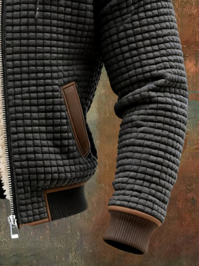 Close view of the charcoal waffle texture, welt pocket and ribbed cuff