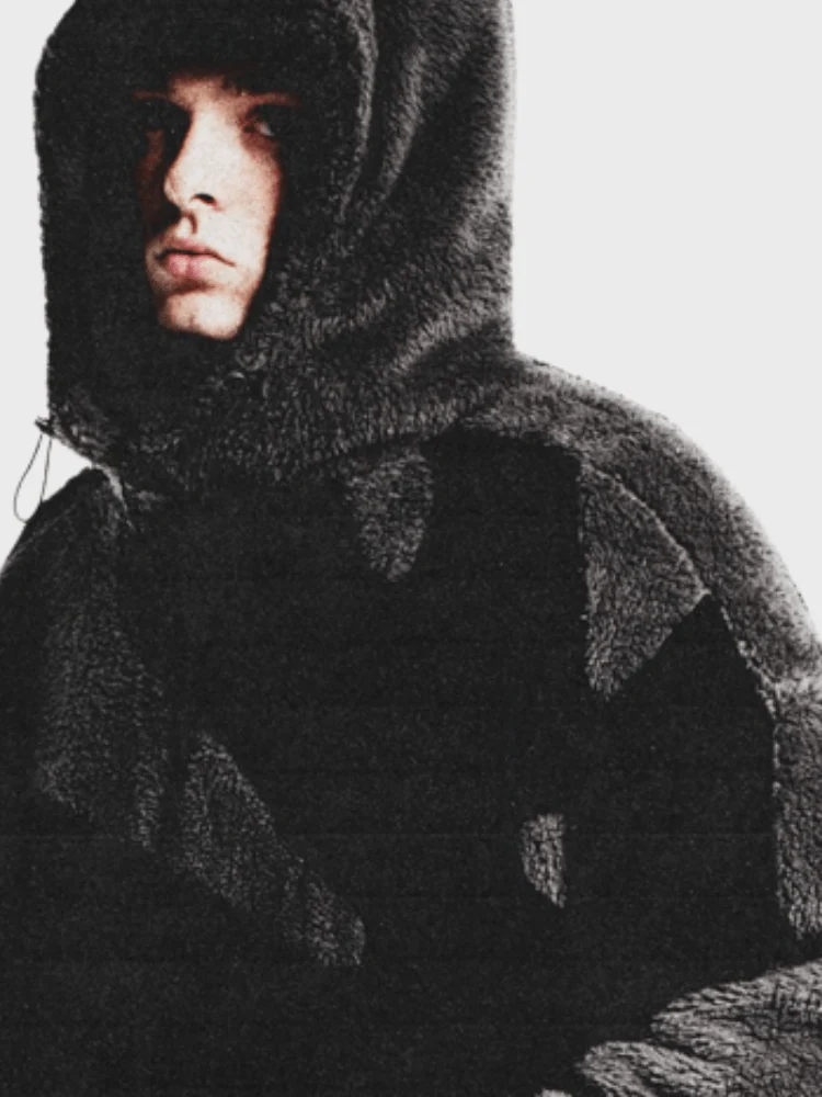 Model wearing the black fleece jacket with the hood up