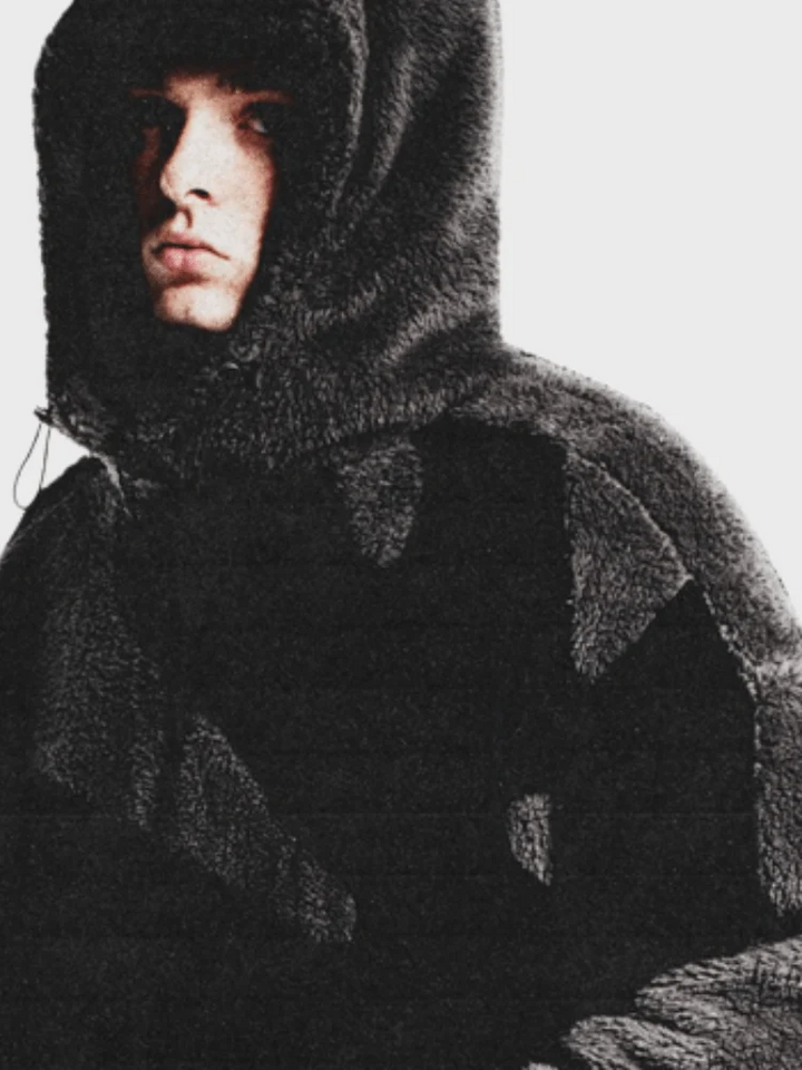 Model wearing the black fleece jacket with the hood up