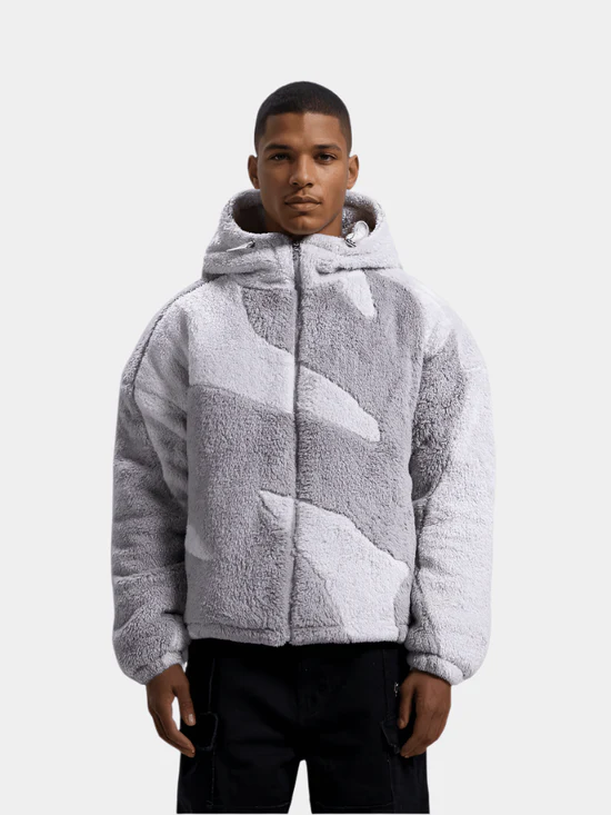 Grey hooded fleece jacket worn zipped with black trousers
