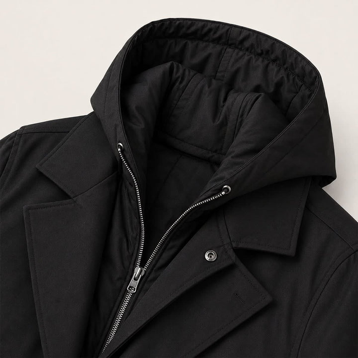Close up of the hood, inner zip and notch lapel on the black coat