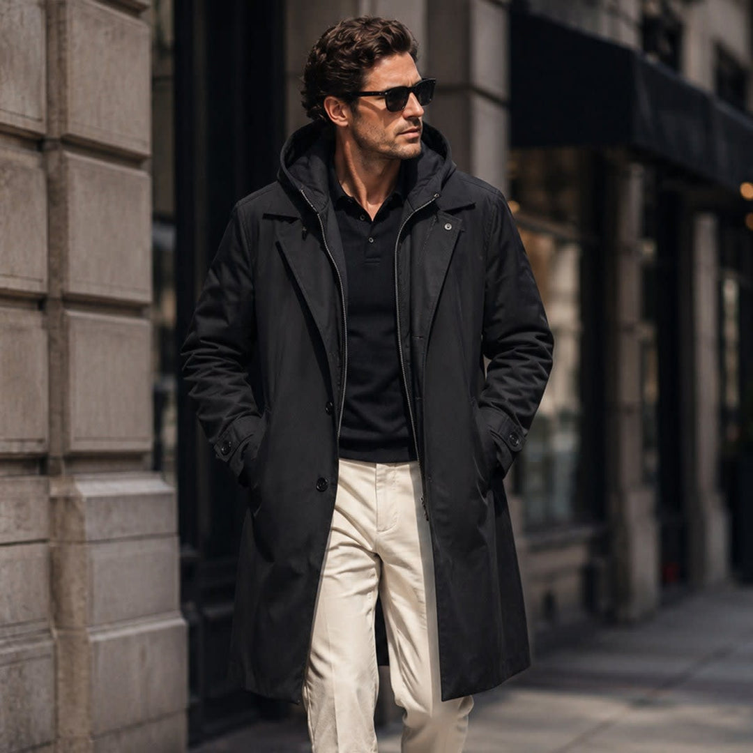 Black parka coat worn with cream trousers on a city street