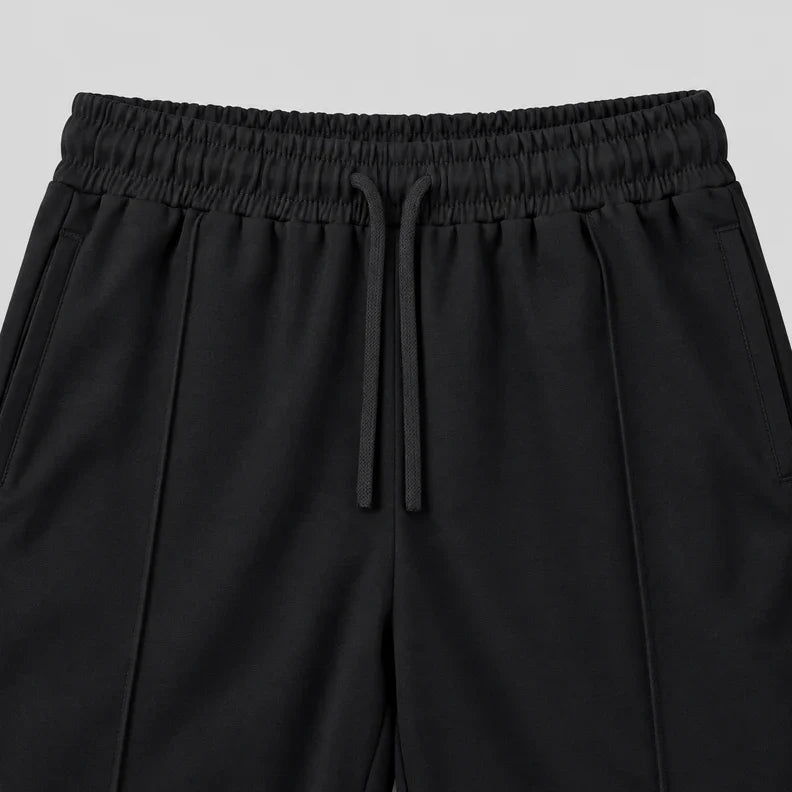 Black joggers waistband with a flat drawstring and pintuck seams