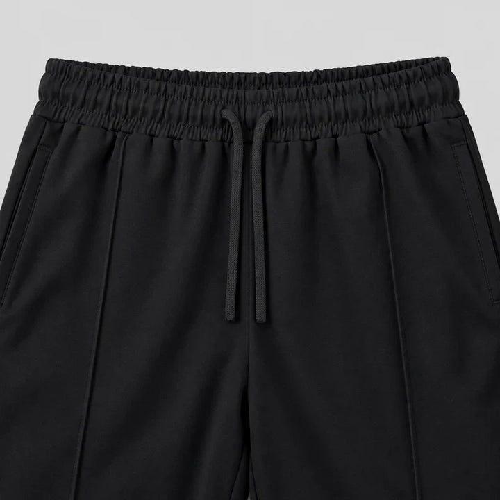 Black joggers waistband with a flat drawstring and pintuck seams