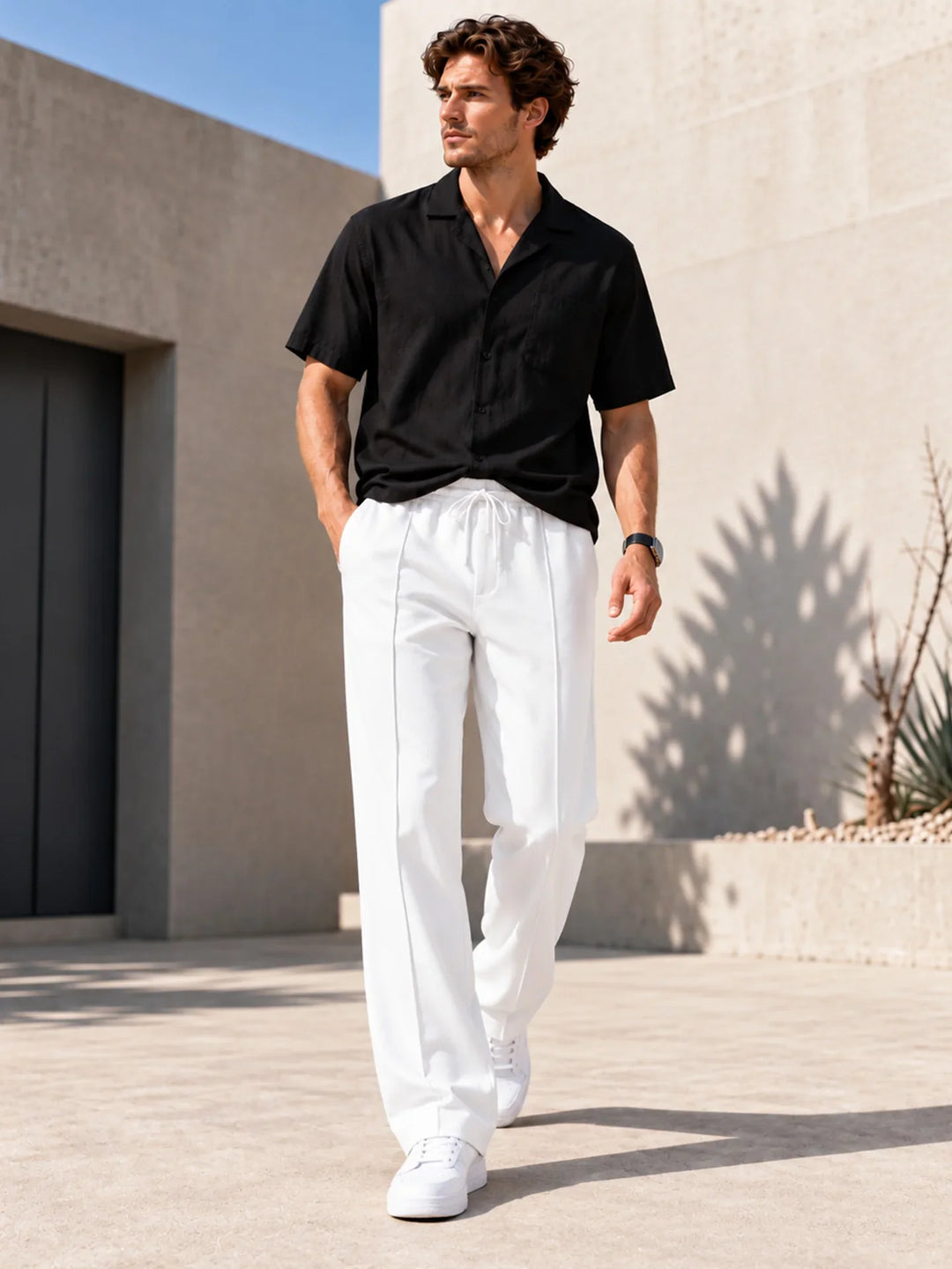 Men's straight leg joggers in white with a drawstring waist worn with white trainers