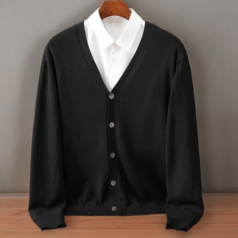 Black V neck cardigan on a hanger over a white shirt