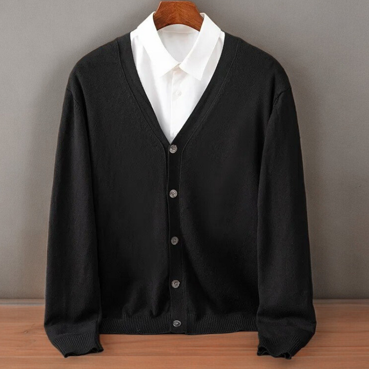 Black V neck cardigan on a hanger over a white shirt