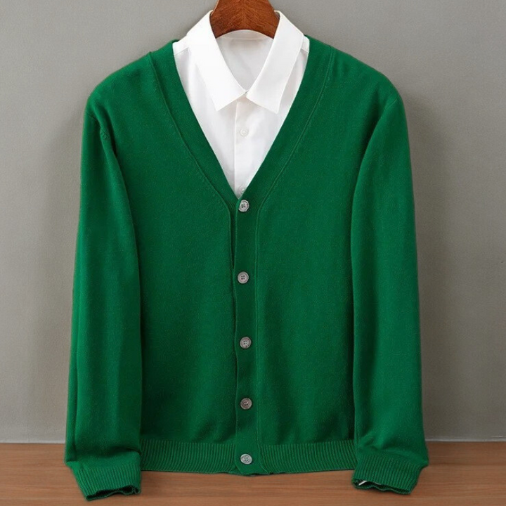 Emerald green V neck cardigan on a hanger over a white shirt