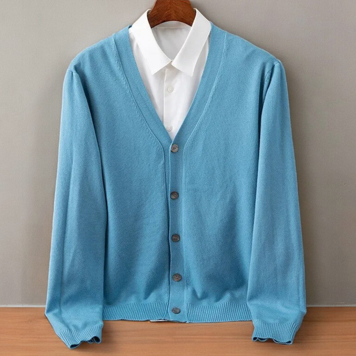 Sky blue V neck cardigan on a hanger over a white shirt