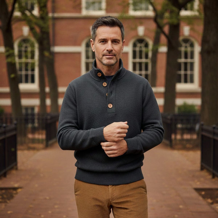 Man in the charcoal jumper with tan chinos on an autumn street
