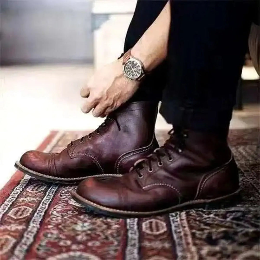 Dark brown lace up boots being tied on a patterned rug