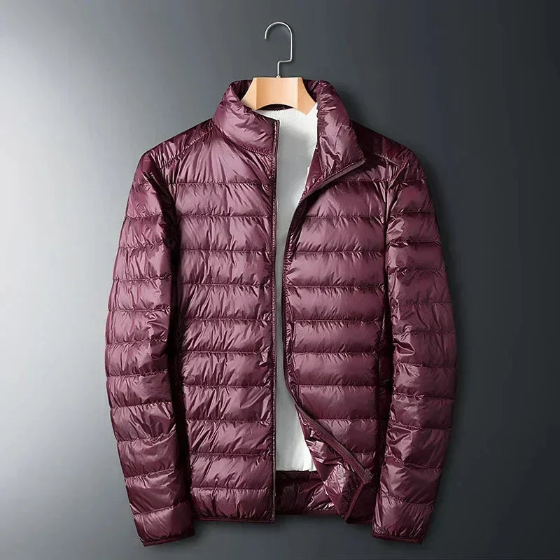 Burgundy lightweight puffer jacket on a hanger with stand collar