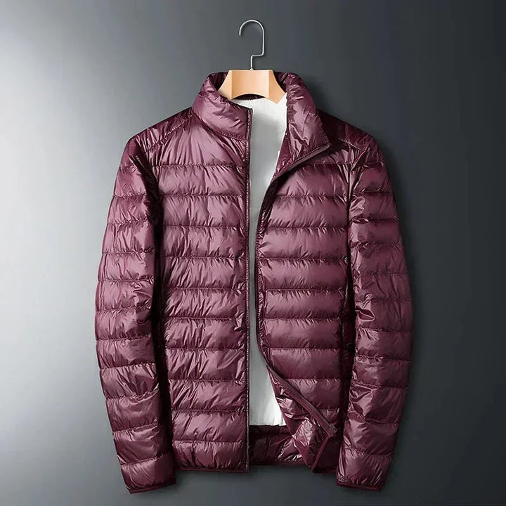 Burgundy lightweight puffer jacket on a hanger with stand collar