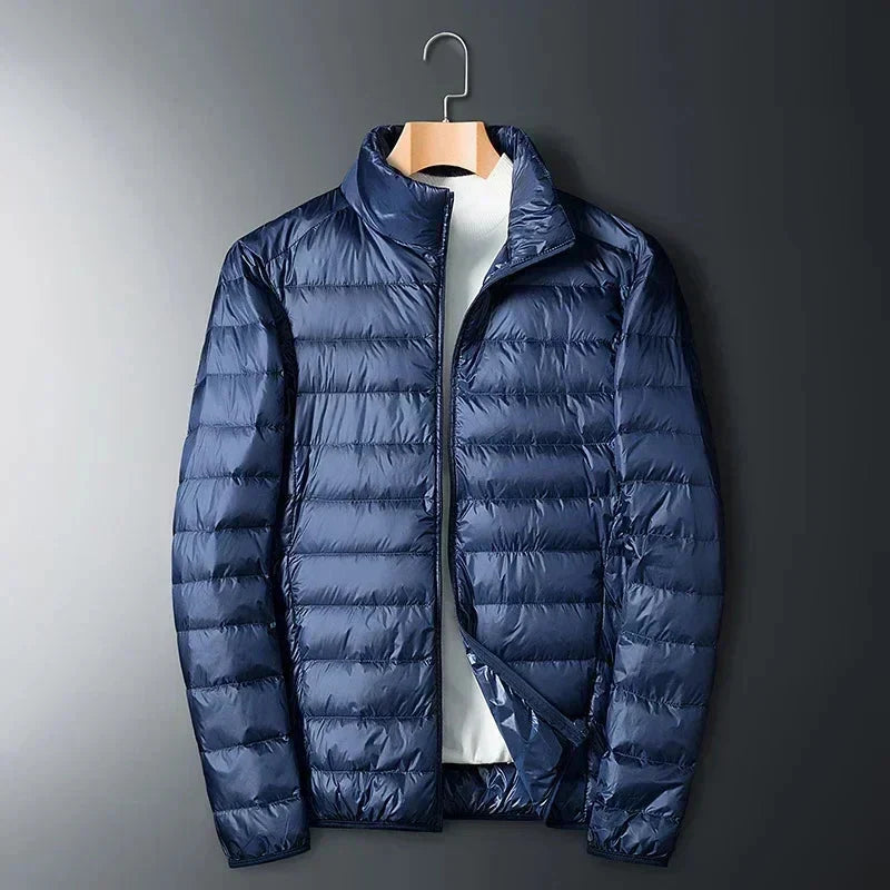 Navy packable puffer jacket on a hanger, front view