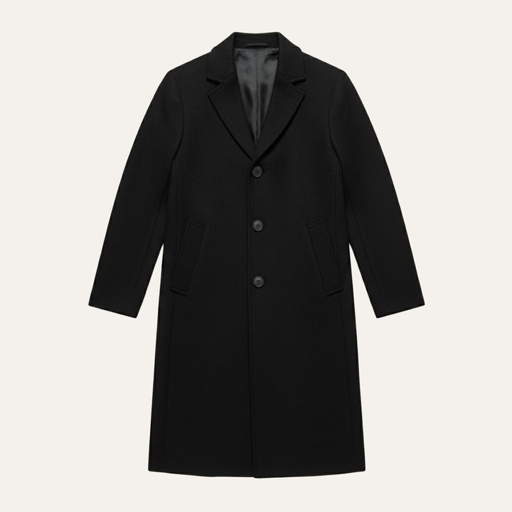 Black overcoat laid flat with the full length visible