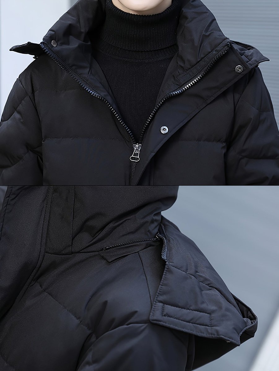 Close up of the zip and snap button placket on the black puffer coat
