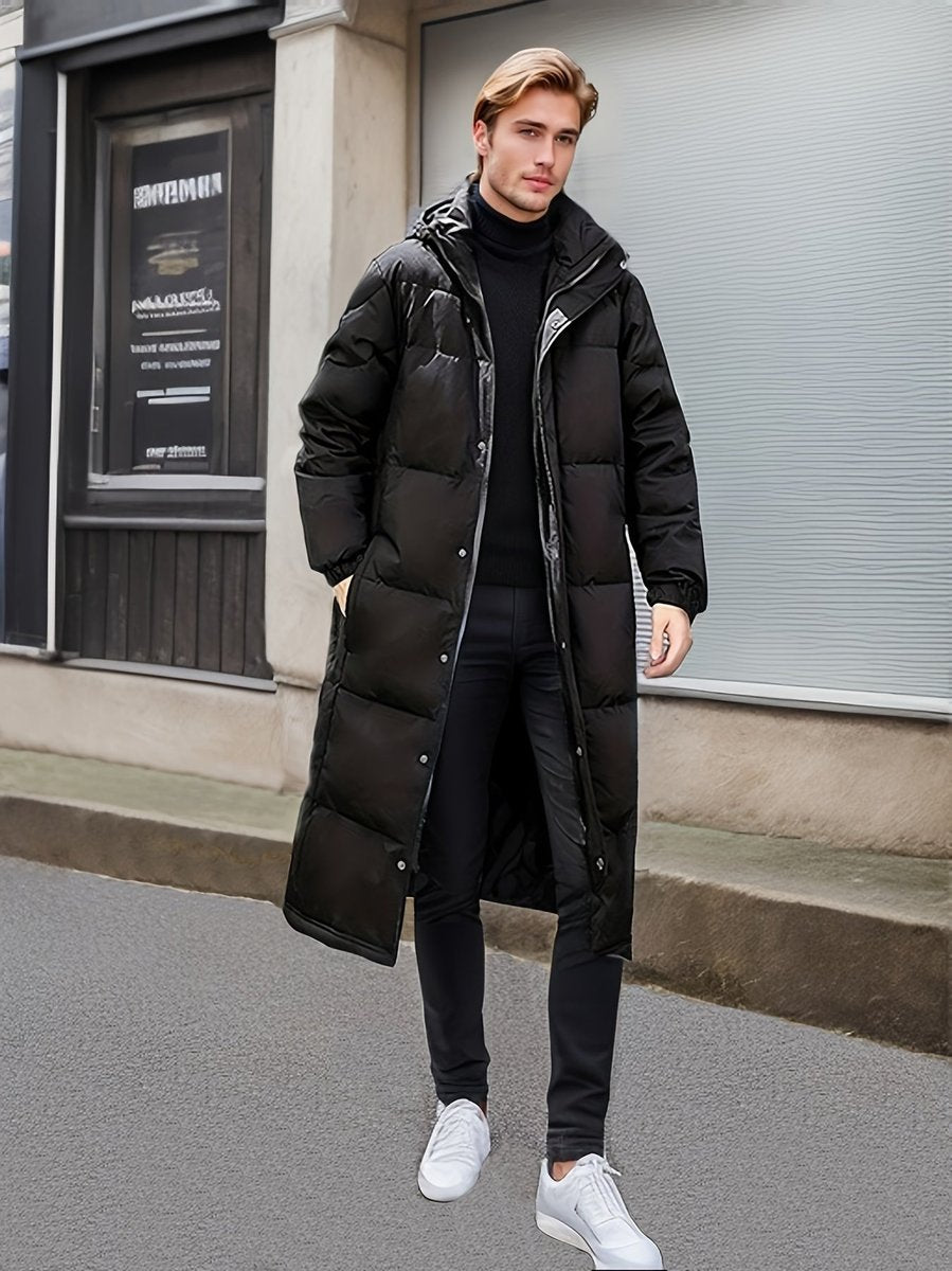 Man wearing the black long puffer coat open over a roll neck