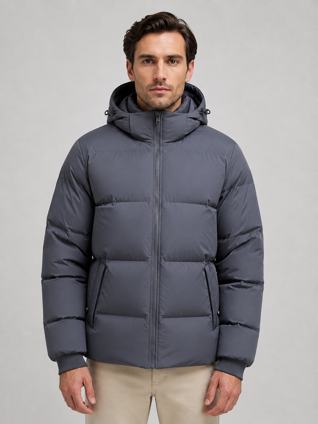 Dark grey hooded puffer jacket zipped up, front view