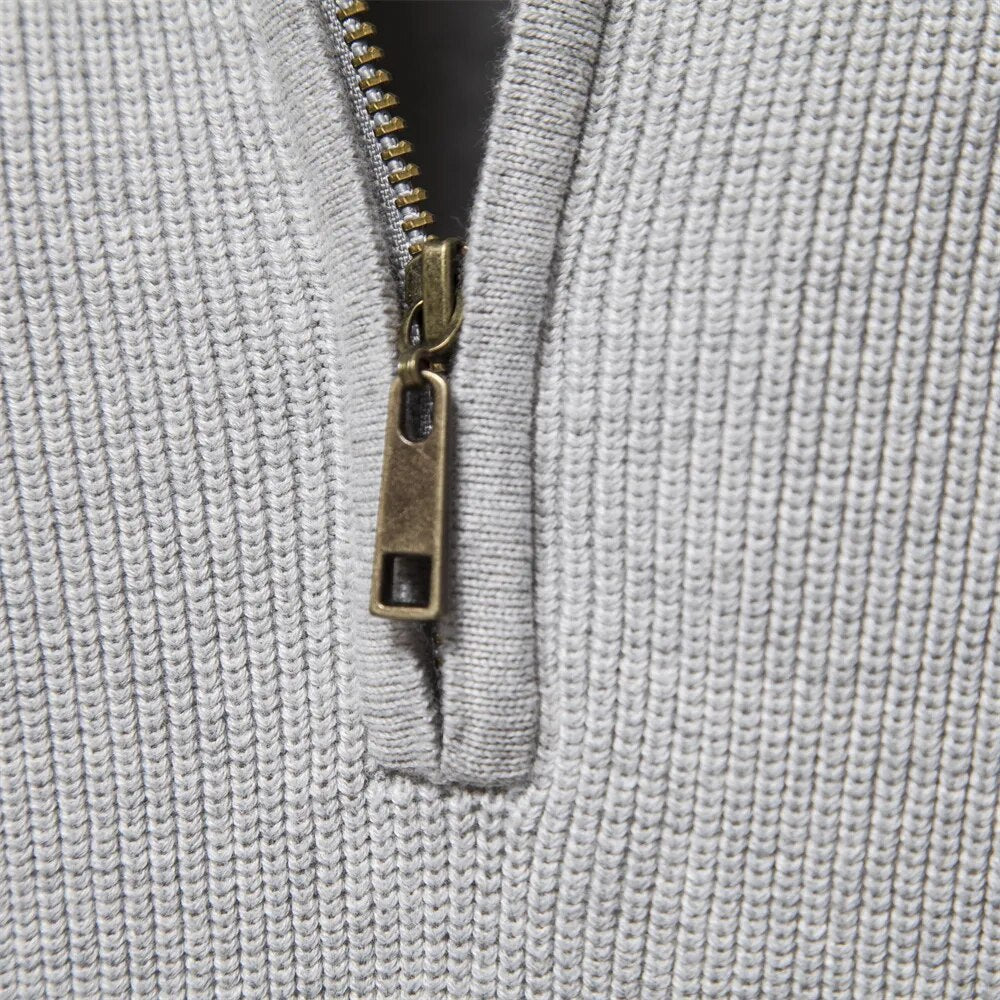 Metal zip pull on the light grey jumper collar