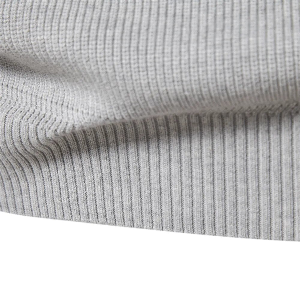 Ribbed hem band of the light grey quarter zip jumper