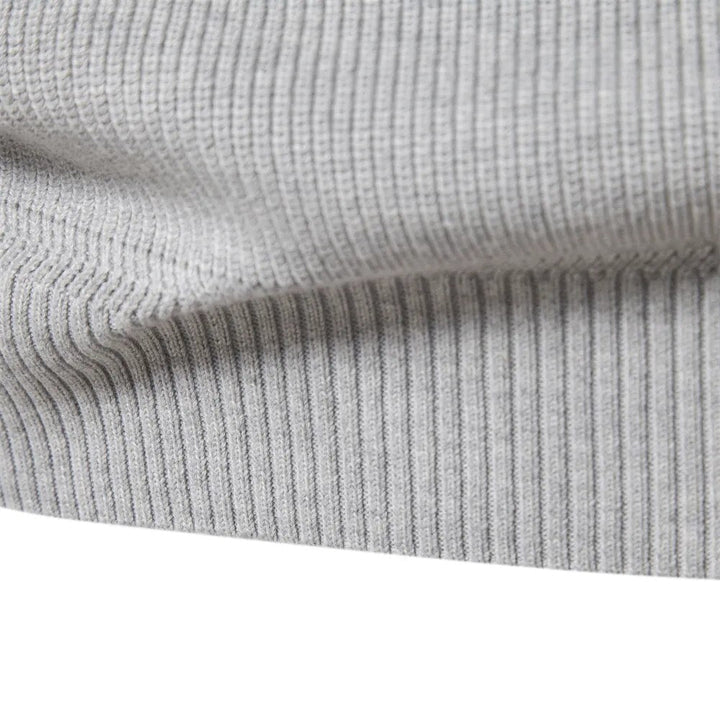 Ribbed hem band of the light grey quarter zip jumper