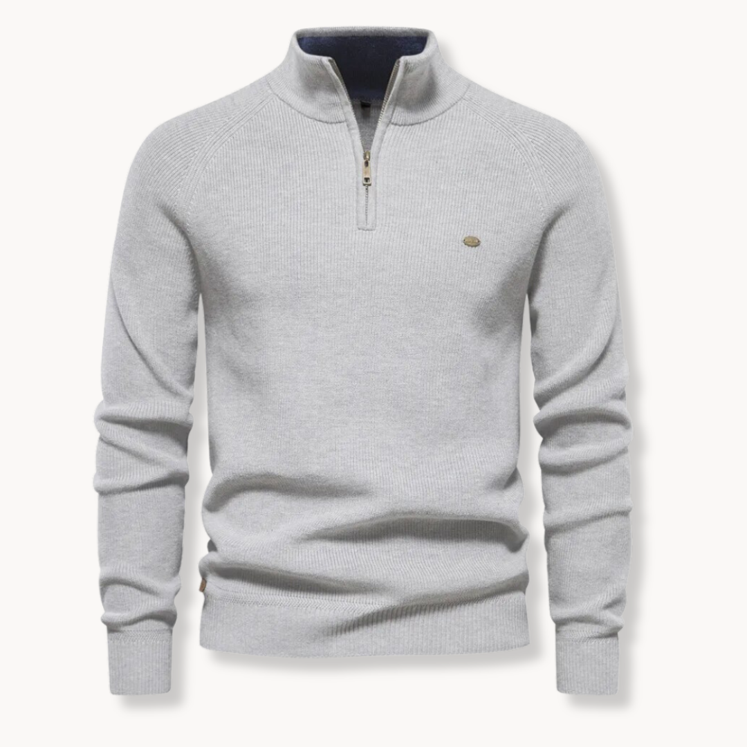 Light grey quarter zip jumper laid flat with ribbed cuffs and hem