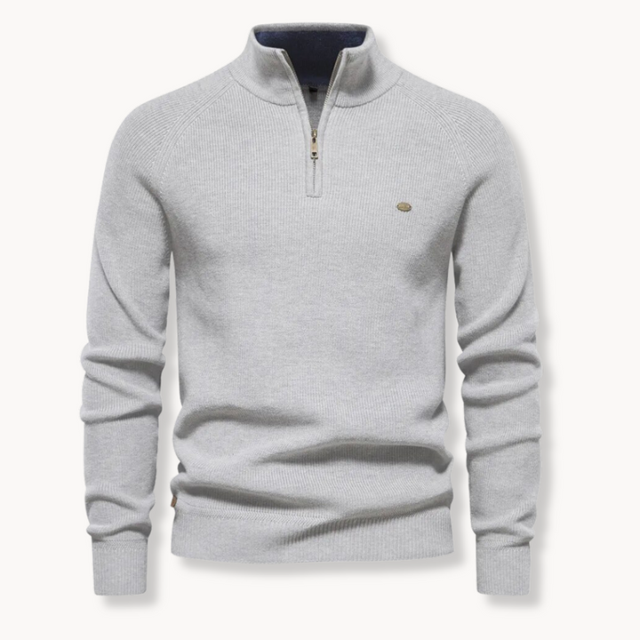 Light grey quarter zip jumper laid flat with ribbed cuffs and hem