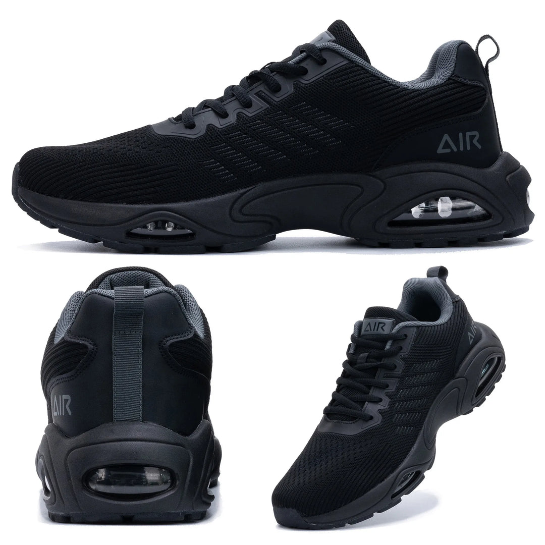 Black trainers, held up to show the inside and the sole