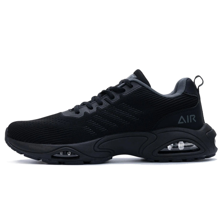 Black trainers, side view on a plain background