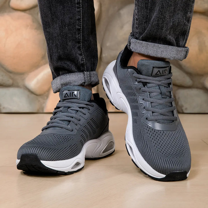 Dark Grey trainers, worn on foot, front view