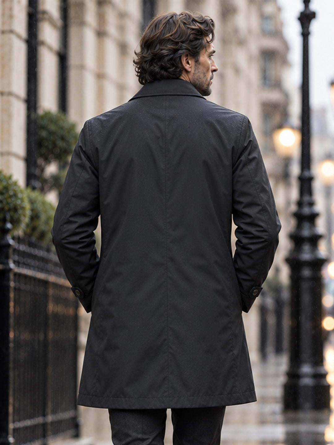 Back view of a black single breasted coat on a city street