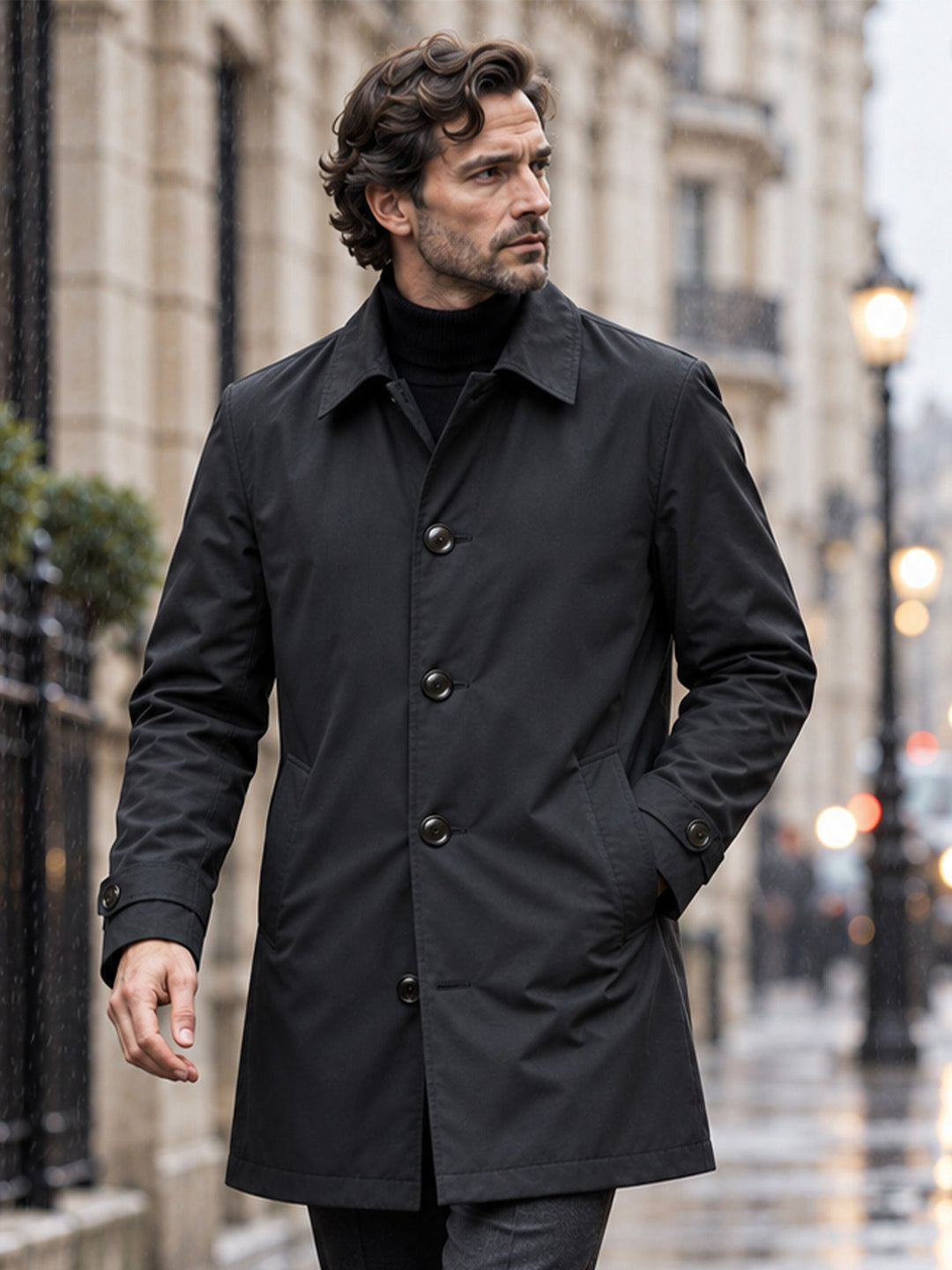 Black single breasted coat with hands in pockets, seen from the front