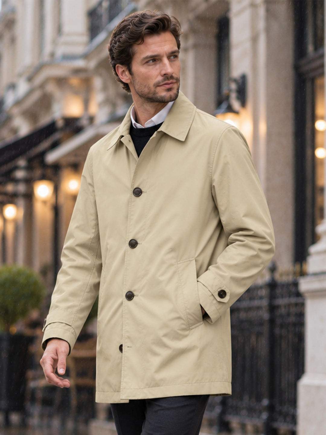 Khaki mid length coat with hands in pockets, seen from the front