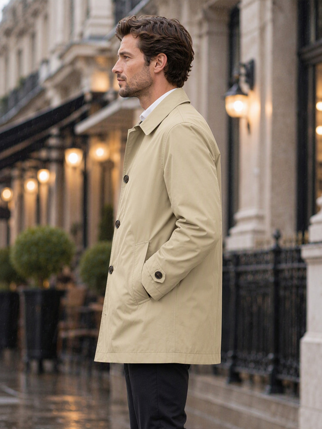 Khaki coat seen from the side with a button cuff tab