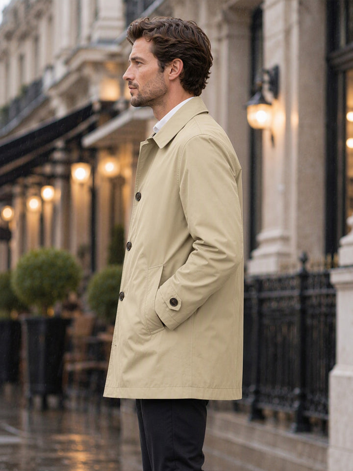 Khaki coat seen from the side with a button cuff tab