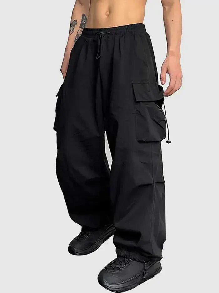 Men's wide leg cargo trousers in black with drawstring waist and toggle cuffs