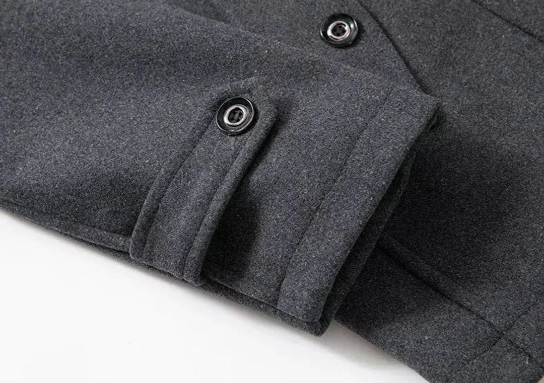 Grey coat cuff with a buttoned tab