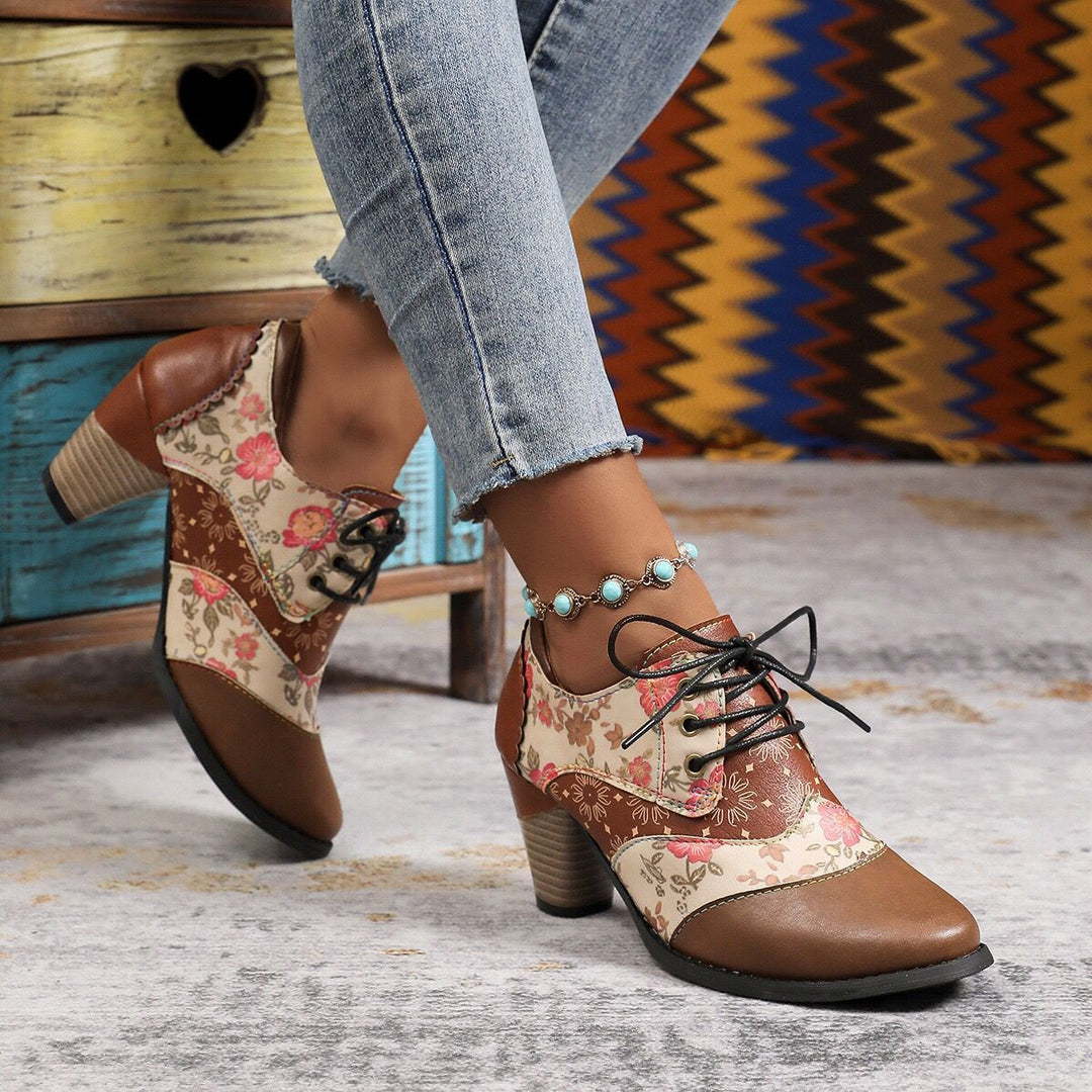Cream Floral ankle boots, worn on foot, walking pose