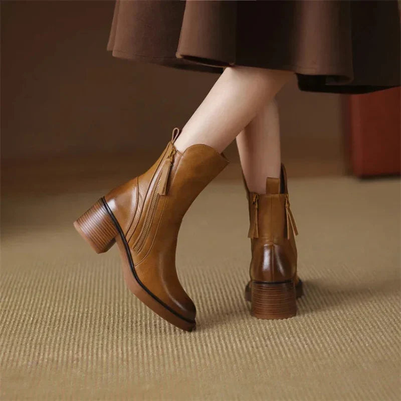 Brown boots from the back with pull loop and ridged heel