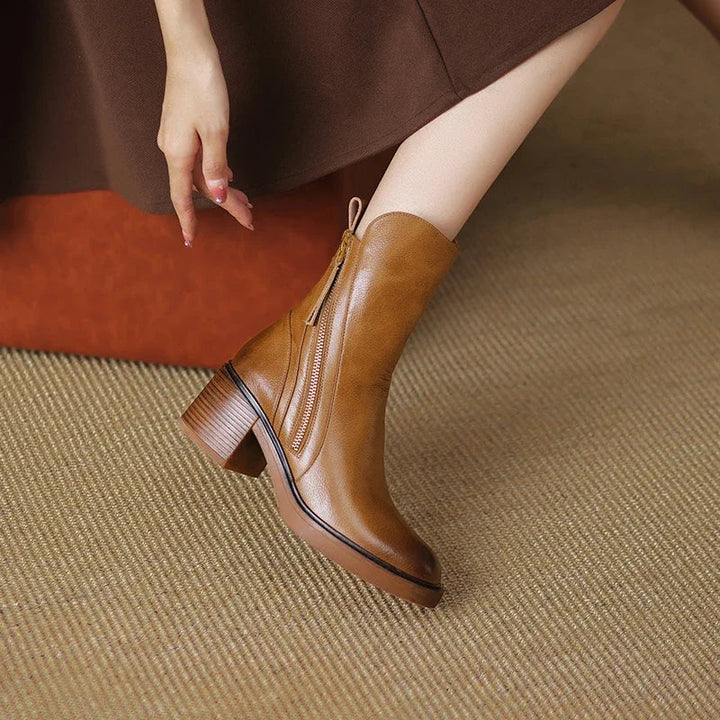 Brown ankle boot on foot showing the side zip and curved seams