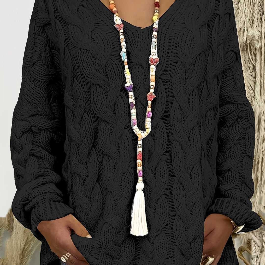 Black cable knit jumper with V neckline worn with a long beaded necklace